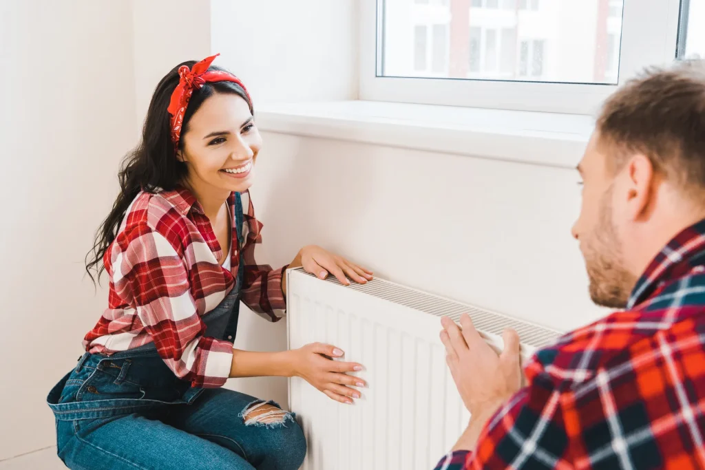 man and woman touching heating machine